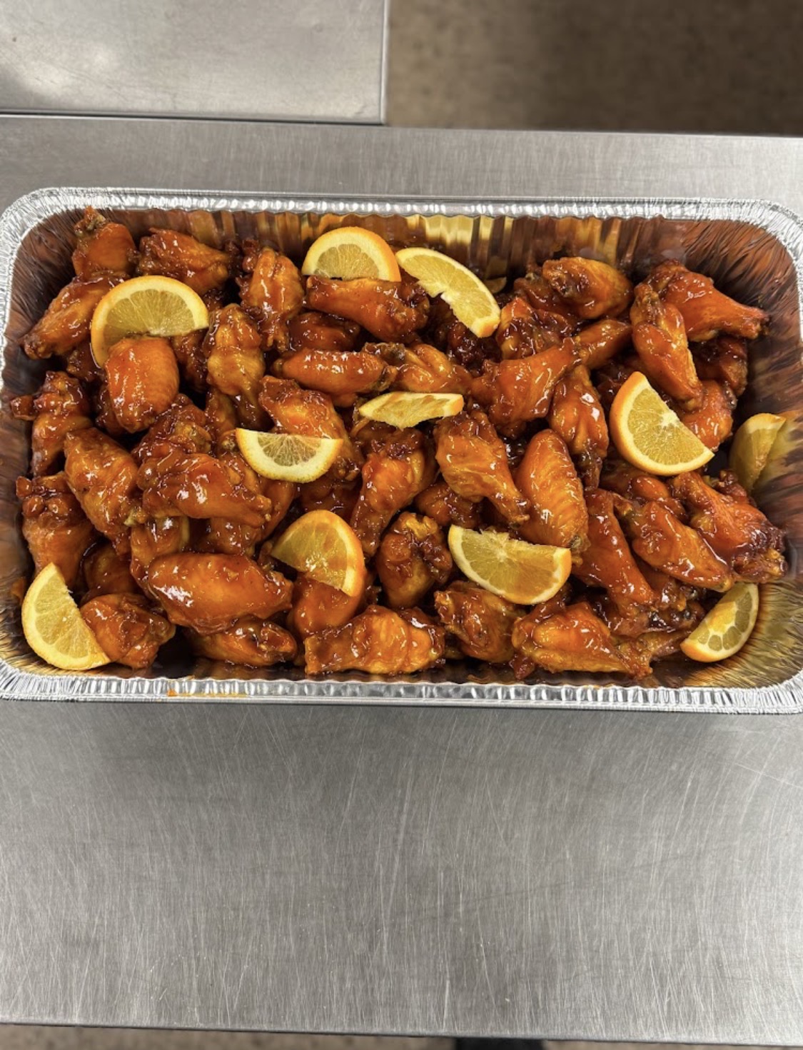 Catering tray of honey glazed orange wings